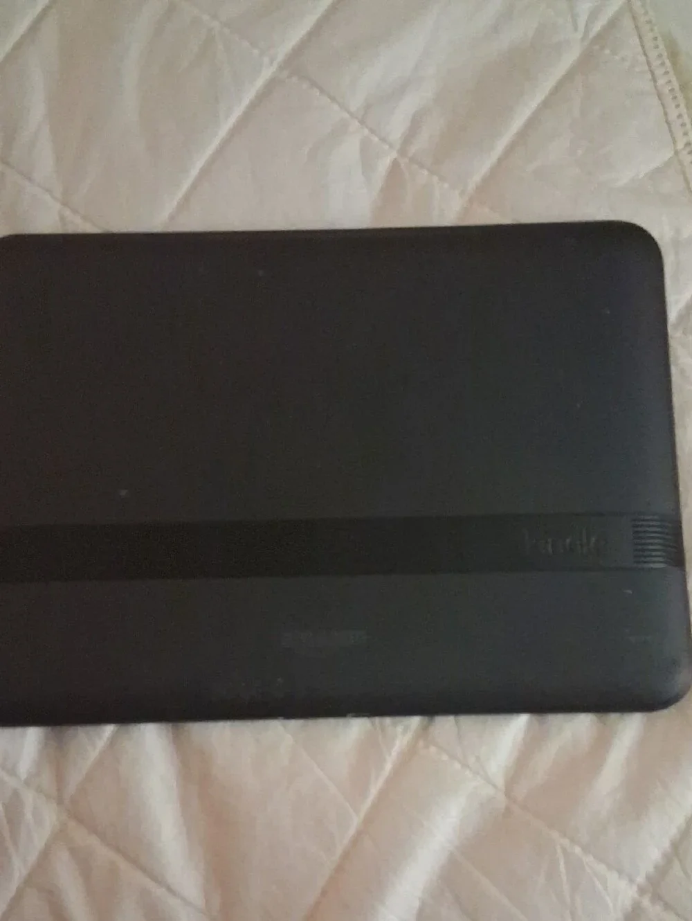 Amazon Kindle with blue case with stickers on
